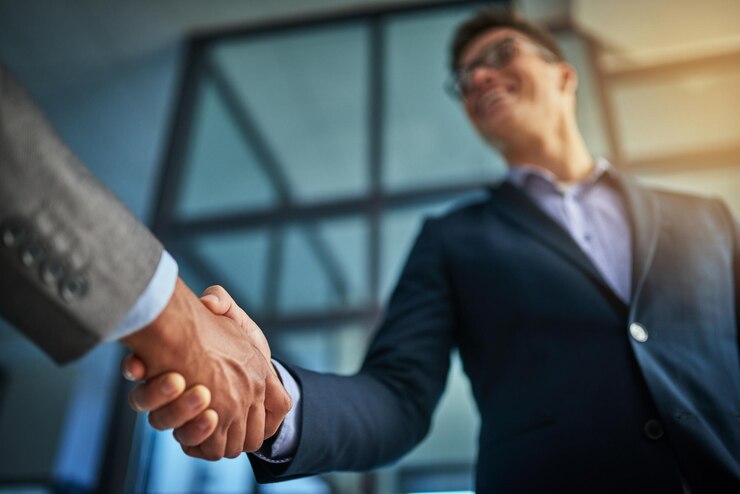 professional-handshake-after-successful-group-collaboration-meeting-after-modern-corporate-office-young-man-shaking-customers-hands-after-sealing-business-contract-deal-company_590464-77696